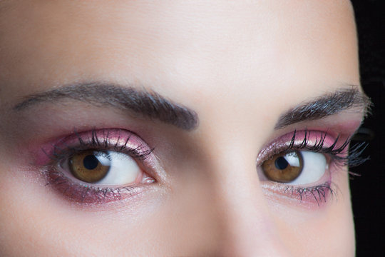woman eyes with perfect pink  wet eyeshadow closeup studio