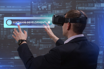 Business, Technology, Internet and network concept. Young businessman working on a virtual screen of the future and sees the inscription: Software development