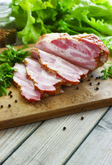 Slices of bacon on the wooden background. Brisket