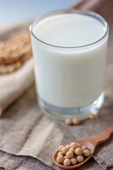 Soy milk with soy beans around it.