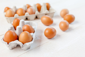 Close-up view of raw chicken eggs on wooden background