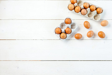 Raw eggs on wooden table, top view, free space