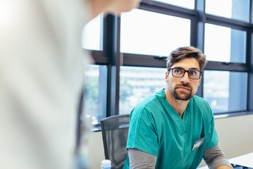 Medical professional during briefing in boardroom