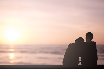 silhouette adult lovers couple sitting lean together on nature background at the beach,happy romantic moment concept