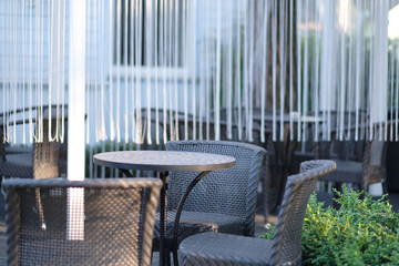 Sets of woven garden furniture on the wooden dais of the residence