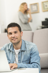 Fototapeta premium Young man watching internet on his laptop