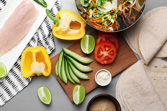 Ingredients for fish tacos on grey background