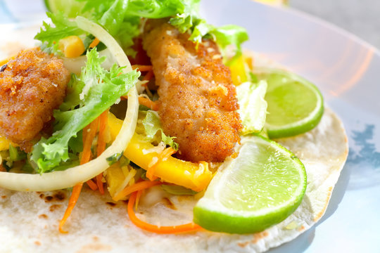 Delicious fish taco on plate, close up