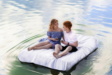 Fototapeta na wymiar Pair the mattress with daisies , a date on the river , floating.