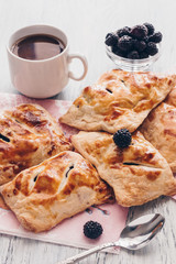 Puff cakes with berries and a cup of coffee.