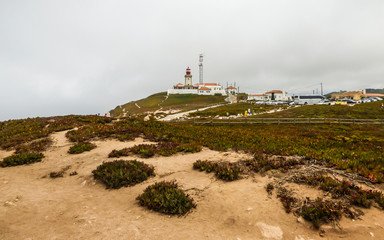 Fototapeta na wymiar Cabo da Roca's Lighthouse on a cloudy, misty day (Sintra, Portugal)