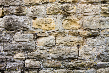 Old brown, gray and ocher stone bricks