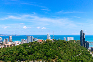 Fototapeta na wymiar High Pattaya ocean view. Blue sky with clouds, summer green trees, Thailand beach