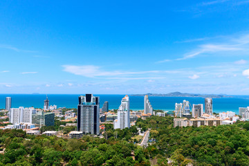 High Pattaya ocean view. Blue sky with clouds, summer green trees, Thailand beach