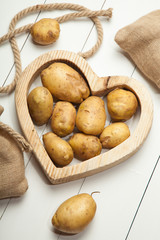 Potatoes and heart on a white background