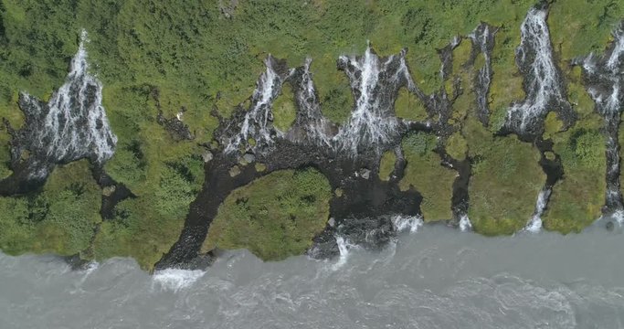 Hraunfoss lava spring waterfall glacial river Iceland aerial looking down slow motion 4k