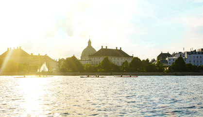 Frederik's Church (Frederiks Kirke, The Marble Church, Marmorkirken) and Copenhagen cityscape, Denmark. Old buildings on a canal bank, panoramic view of European city, dramatic sky at the sunset