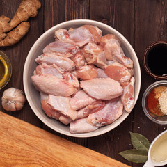 raw chicken wings on a wooden table.