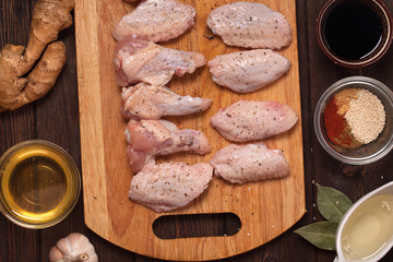 raw chicken wings on a wooden table.