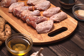 raw chicken wings on a wooden table.