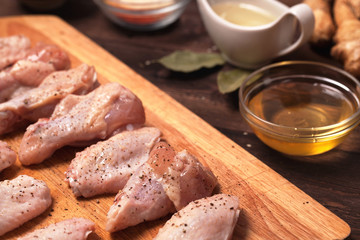 raw chicken wings on a wooden table.