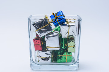 Tiny presents in a square glass