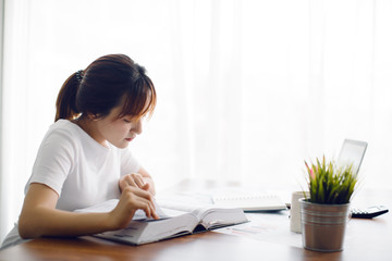 Young Asia woman reading a book in the office