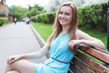 girl sitting on a bench in the park