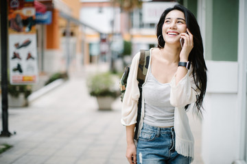 Asia woman using phone at shopping mall