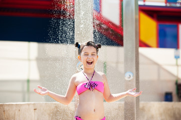 Little girl bathes in the shower