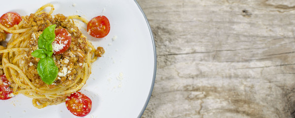  Italian spaghetti bolognese on wood background