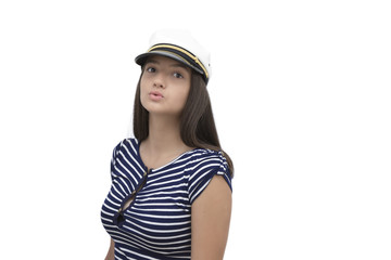 young model posing in sailor clothes posing over white background 