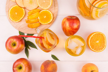 Ice tea with fresh fruit on a wooden background