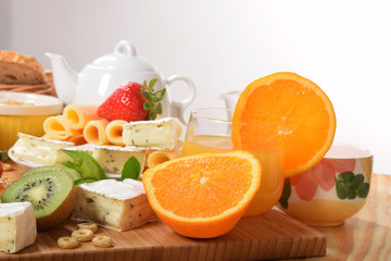 Strawberry orange and kiwi fruit on a dietetic breakfast  With yellow Swiss cheese andWhite french with mold and pepper