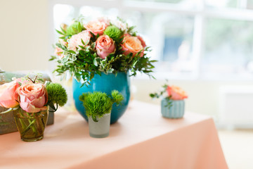 Vase with flowers and table set for event party or wedding. The flowers decoration on the wedding table