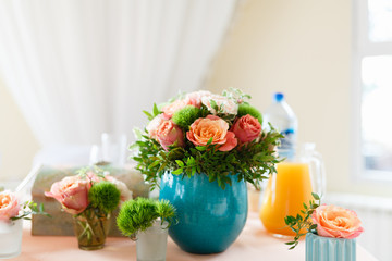 Vase with flowers and table set for event party or wedding. The flowers decoration on the wedding table