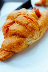 Fresh Croissants on the white plate. Selective focus