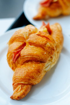 Fresh Croissants on the white plate. Selective focus