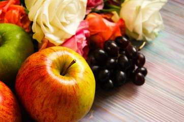 Roses, grapes and apples closeup