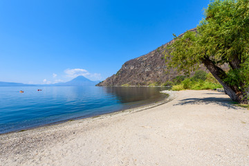 Paradise beach at lake Atitlan, Panajachel - Relaxing and recreation at beach with vulcano landscape scenery in the highlands of Guatemala