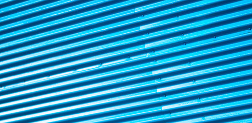 Bright blue corrugated iron sheets door close up for background