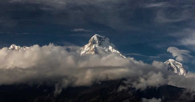 Timelapse with beautiful clouds over Annapurna South with beautiful colours. Himalaya Mountain, Nepal
