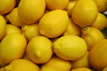 Heap of Vivid Yellow Lemons, Top View for Background, Banner, Texture 