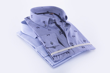 Two men's shirts folded on a white background. Isolated