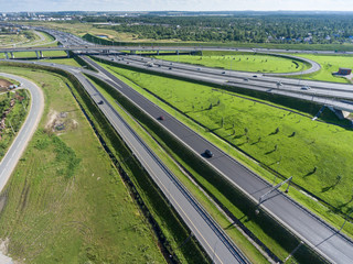 Exits of city ringroad with green grass around. Aerial view. St. Petersburg, Russia