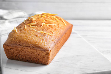 Delicious citrus cake with orange zest on table