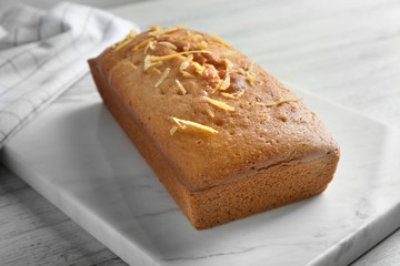 Delicious citrus cake with orange zest on table