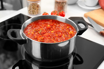 Stewpan with ready turkey chili on stove
