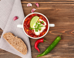 Casserole with delicious chili turkey on wooden background