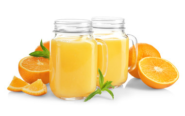 Composition with mason jars of fresh juice and oranges on white background